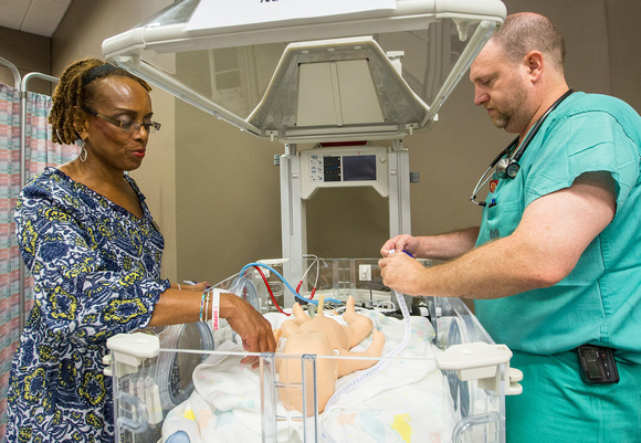 Pamela Reis, assistant professor CON, and John Bailey during midwifery training.