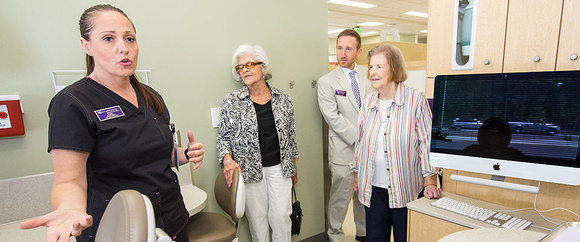 Dental hygienist Roberta Bunnell leads a tour before the ceremony begins.